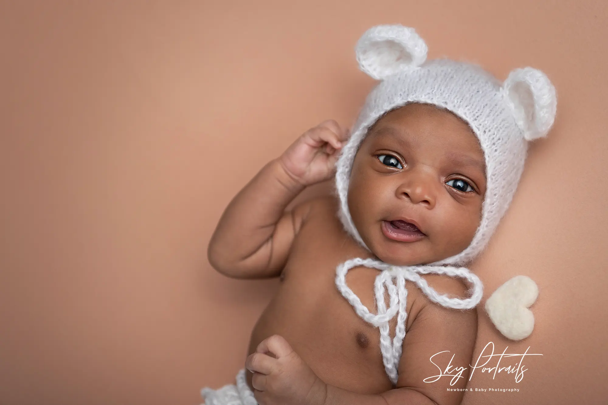 Close-up of newborn's smile at Sky Portraits Studio, Sydney - newborn photography specialist
